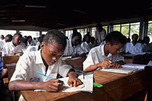 Tanzania Prints: Students in a classroom at their desks writing, Moshi, Tanzania