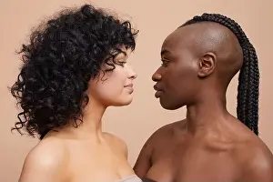 Homosexual Couple Prints: Studio portrait of beautiful women standing face to face