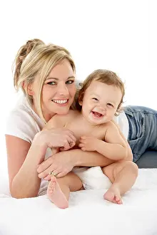 Cuddling Prints: Studio Portrait Of Mother With Young Baby Boy