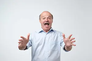 Anxious Prints: Studio shot of mature hispanic man against gray background