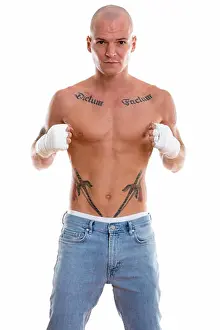 Bald Prints: Studio shot of young handsome bald muay thai fighter standing an