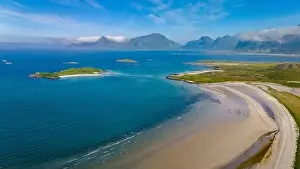 A stunning aerial view of a pristine white sand beach nestled between verdant green islands