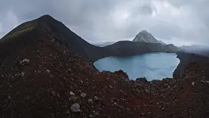 Stunning drone-shot panorama showcasing a striking volcanic lake nestled in Iceland's rugged highlands