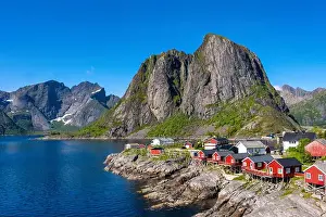 Stunning fjord landscape Lofoten Islands in Norway, featuring charming red cabins by the water