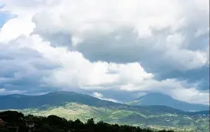 Stunning landscape with green hills and mountains during a cloudy day