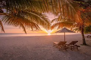 Sunset Beach Prints: Stunning sunset beach scene. Chairs on the sandy beach near the sea
