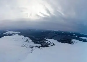 Top Hill Prints: Stunning view of the cliffs covered with snow and trees on a cloudy winter day at the ski resort