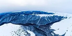 Top Hill Prints: Stunning view of the cliffs covered with snow and trees on a cloudy winter day at the ski resort