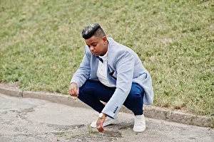 Happy Human Prints: Stylish arabian man in jacket, bow tie posed outdoor. Arab model boy