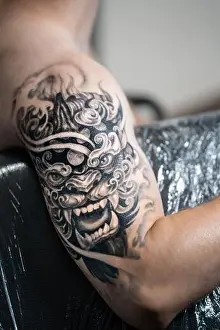 Samurai Prints: stylish black tattoo of Japanese demon mask on man hand, body art