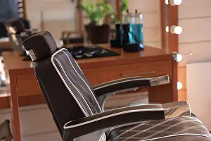 Stylist Prints: Stylish hairdresser's workplace with professional armchair in barbershop, closeup