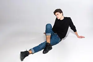 Sits Prints: Stylish handsome man posing sitting on floor