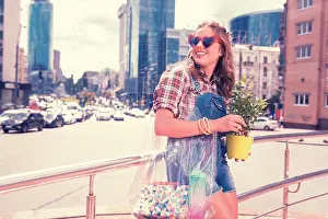 Business Center Prints: Stylish modern woman holding her transparent bag and green home plant