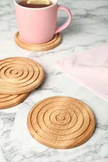 Coaster Prints: Stylish wooden cup coasters on white marble table
