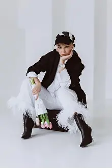 Bouquet Of Flowers Prints: A stylish young woman in a light suit with feathers