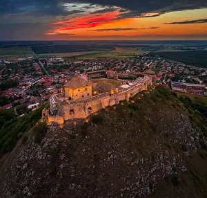 Veszprem Prints: Sumeg, Hungary - Aerial view of the famous illuminated High Castle of Sumeg in Veszprem county at sunset with colorful
