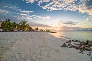 Summer beach landscape. Luxury vacation and holiday concept, summer travel banner. Panoramic landscape of sunset beach, two loungers umbrella, palms