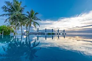 Summer beach swimming pool on sunny day with reflection of palm trees, tropical landscape, exotic island hotel resort concept. Luxury infinity pool
