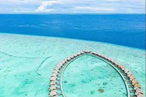 Summer landscape and seascape as aerial tropical background. Amazing view from above, luxury water bungalows, vacation holiday mood. Pristine clear