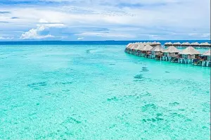 Summer landscape and seascape as aerial tropical background. Amazing view from above, luxury water bungalows, vacation holiday mood. Pristine clear