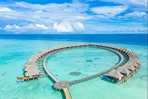 Summer landscape and seascape as aerial tropical background. Amazing view from above, luxury water bungalows, vacation holiday mood. Pristine clear
