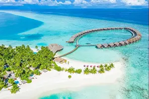 Summer landscape and seascape as aerial tropical background. Amazing view from above, luxury water bungalows, vacation holiday mood. Pristine clear