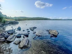 Water Reflections Prints: Summer serenity at Lake Inari – where endless daylight meets pristine Nordic beauty