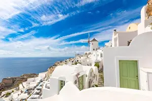 Summer travel destinations. Picturesque cityscape of Oia village in Santorini island located volcanic caldera. Traditional windmills, luxury vacation