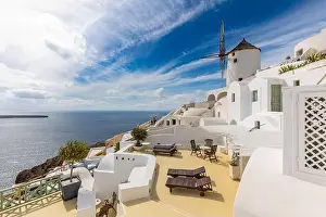 Summer travel destinations. Picturesque cityscape of Oia village in Santorini island located volcanic caldera. Traditional windmills, luxury vacation