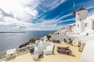 Summer travel destinations. Picturesque cityscape of Oia village in Santorini island located volcanic caldera. Traditional windmills, luxury vacation