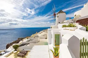 Summer travel destinations. Picturesque cityscape of Oia village in Santorini island located volcanic caldera. Traditional windmills, luxury vacation