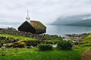 Images Dated 2nd August 2019: Summer view of traditional turf-top church in faroese village