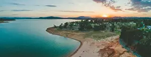 Murray River Prints: Sun disappearing behind mountains near Lake Hume Village - aerial panorama