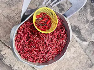 Basin Prints: Sun-dried hot chili peppers stored in aluminum container and small plastic tray outdoors