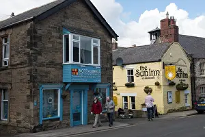 Holiday Destination Prints: The Sun Inn pub and nearby buildings on a village street in Alnmouth