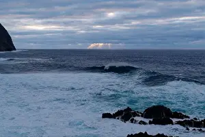 Water Reflections Prints: Sun rays break through the clouds over the atlantic