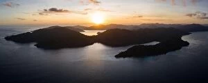 Aerial Landscape Collection: The sun rises over the amazing islands of Raja Ampat, Indonesia. This remote
