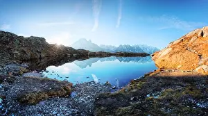 Sun rising on Chesery lake (Lac De Cheserys) in France Alps. Monte Bianco mountain range on background. Landscape photography, Chamonix