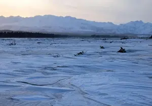 Delta Junction Prints: Sun rising over mountains behind frozen river covered in snow on the winter solstice in interior Alaska