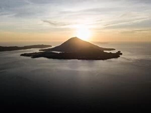Images Dated 9th November 2017: The sun sets behind Banda Neira, an active volcano in the Banda Sea