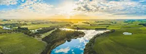 Hopkins River Prints: Sun setting over scenic Australian countryside grasslands and pastures with river passing through - aerial panorama