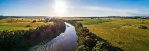 Travel Locations Prints: Sun setting over Snowy River bend and green fields - wide aerial panoramic banner