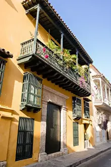 Sun shines on a yellow building in Old Town Cartagena Colombia