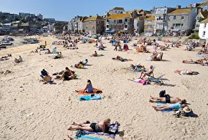 Sunbathers Prints: Sunbathers on a sandy beach in St Ives harbour