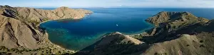 Sunlight illuminates the beautiful coastline of an island near Komodo in Indonesia. This region is known for its spectacular marine biodiversity