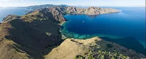 Sunlight illuminates the beautiful coastline of an island near Komodo in Indonesia. This region is known for its spectacular marine biodiversity