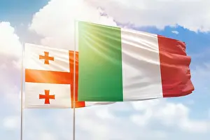 Georgia Prints: Sunny blue sky and flags of italy and georgia