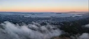 At sunrise, clouds drift over the East Bay hills in the San Francisco Bay area of Northern California