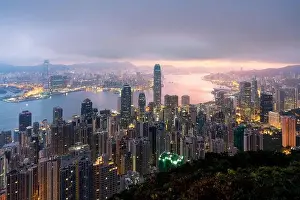 Sunrise over Hong Kong Victoria Harbor from Victoria Peak with Hong Kong and Kowloon below. Asian tourism, modern city life, or business finance and e