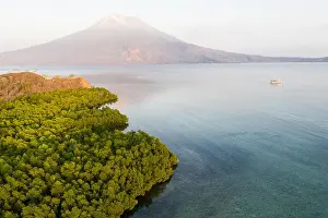 Sunrise illuminates the Iliape volcano found just east of Flores, Indonesia. This tropical area is part of the famous Ring of Fire